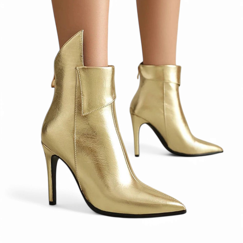 Woman wearing metallic-gold pointed-toe ankle boots with high stiletto heels, front and back visible.	