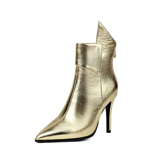 Studio shot of gold chrome boot, pointed toe facing forward.