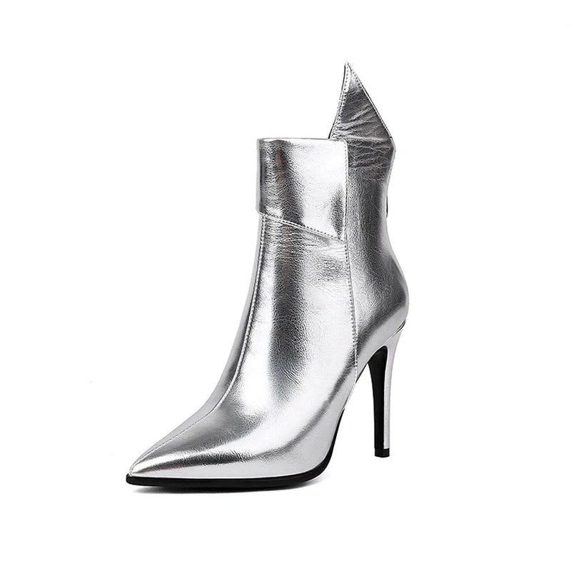 Studio shot of silver chrome boot, mirror-like surface reflecting light.