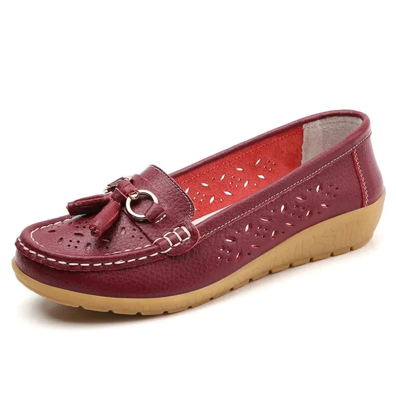 Burgundy tassel loafer with beige outsole, side view