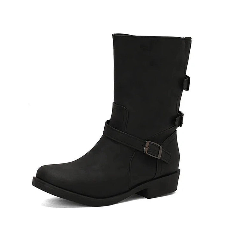 Side profile of the boots showing dual buckle accents, low square heel, and wide-calf fit in black.