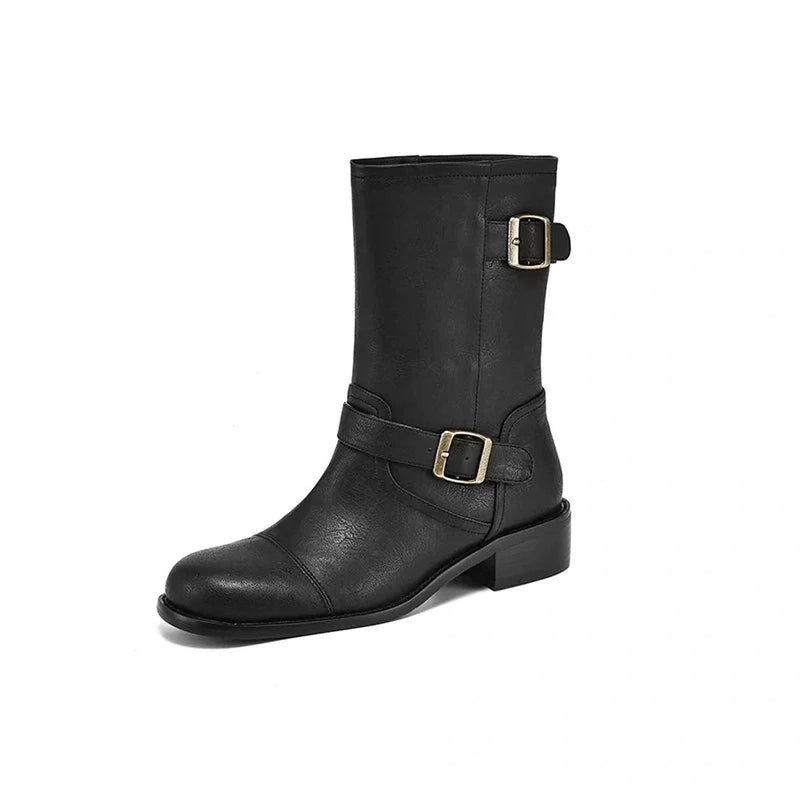 Side angle revealing both metal buckles—one at the ankle strap and one at the shaft—plus the low square heel.