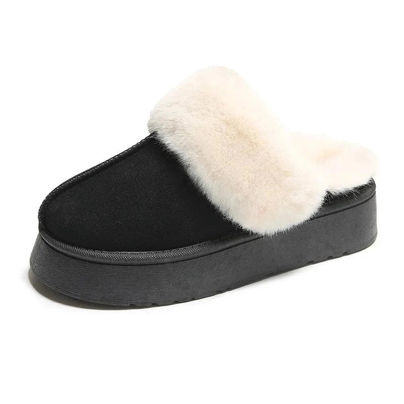 A black slip-on platform slipper with thick faux fur fully surrounding the collar