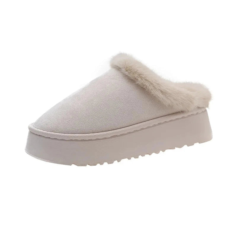 A gray slip-on platform slipper viewed from the side, with a slim faux fur trim outlining the collar.