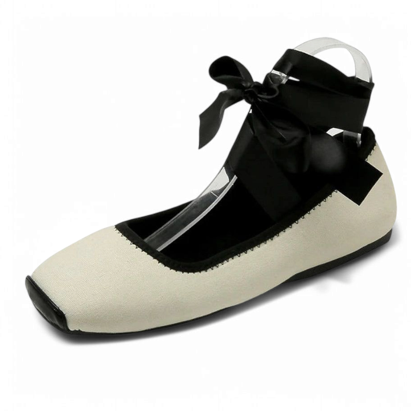 Cream canvas flat with black piping and wide satin tie.