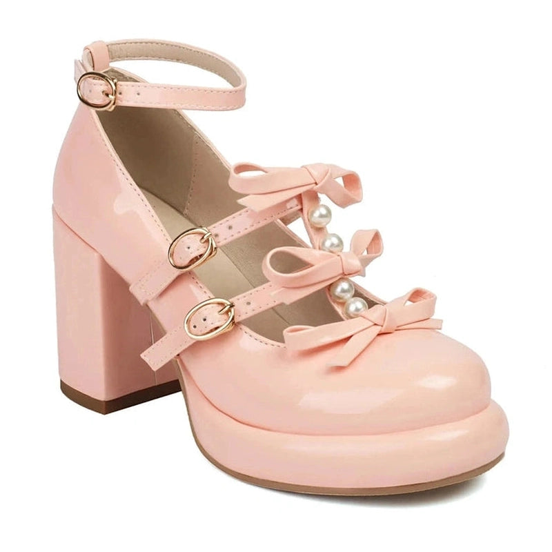 Single pink shoe highlighting chunky heel and platform, gold buckles and bow straps.