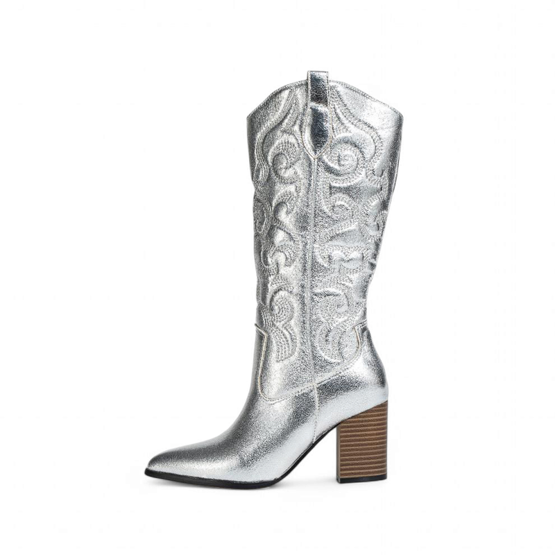 Metallic silver western boot with tall shaft, wide wooden block heel and pointed toe, side view.
