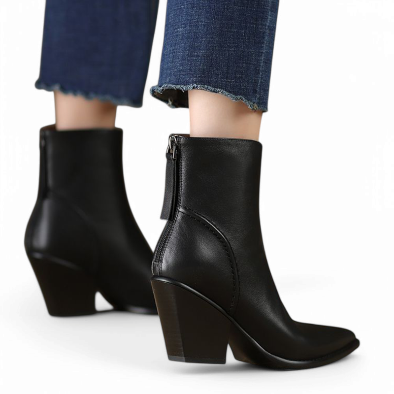 Black ankle boots with angled block heels and back zipper, shown from the rear while worn.

