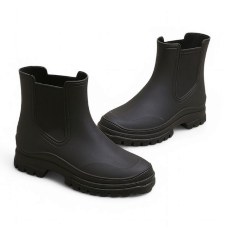 Black waterproof Chelsea boots shown from the side, featuring elastic side panels, chunky sole, and ankle-length shaft.