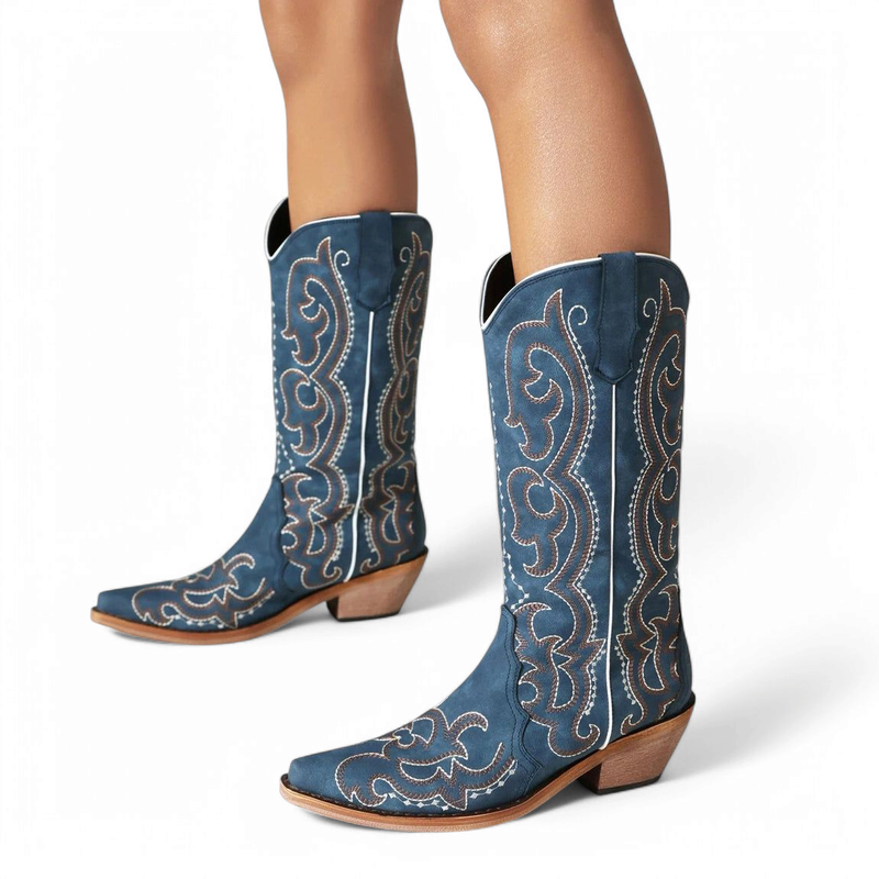Blue boot pair on legs with mid wood heel and pointed toe.


