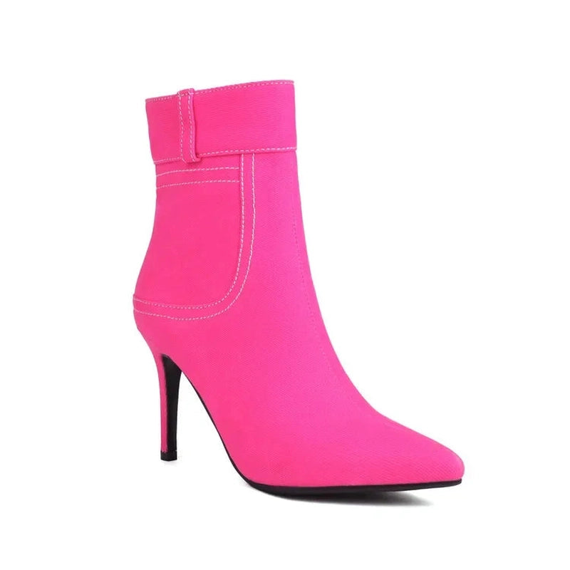 Single bright-pink ankle boot, side profile shows stitched cuff and high heel.