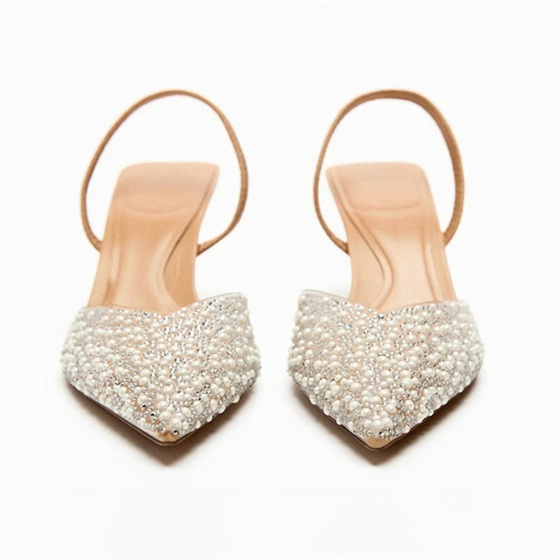 Front shot of pearl-covered pointed toes on white background
