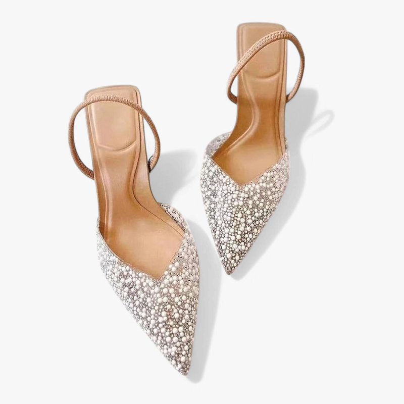 Pearl-embellished pointed pair with slingback straps on white backdrop