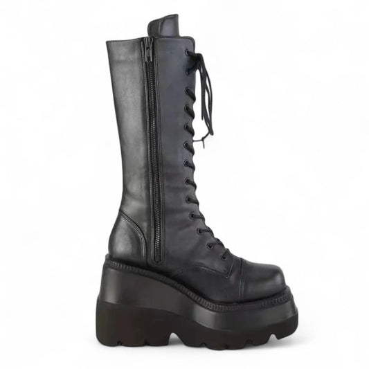 Side view of tall black platform boot with visible zip and chunky sole.