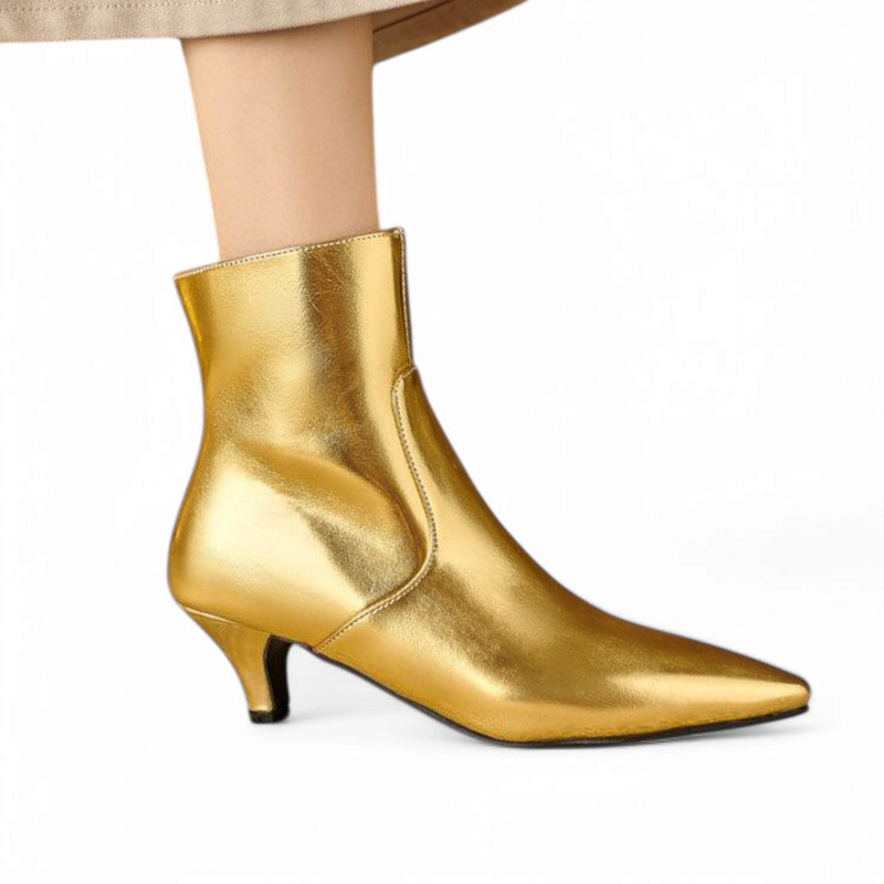 Gold ankle boot side profile, kitten heel touching ground.	