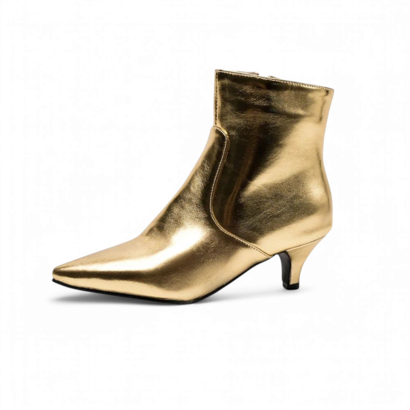 Studio image of single gold ankle boot, white background.