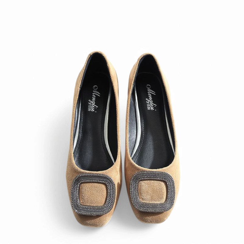 Top-down shot of camel flats revealing black lining and metallic buckle.
