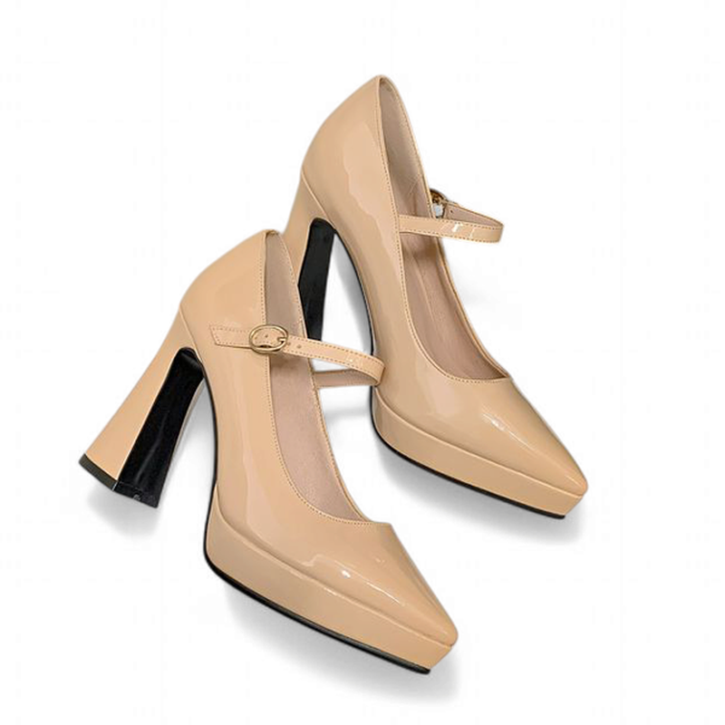Nude Mary-Jane pumps laid flat on white background, pair view.