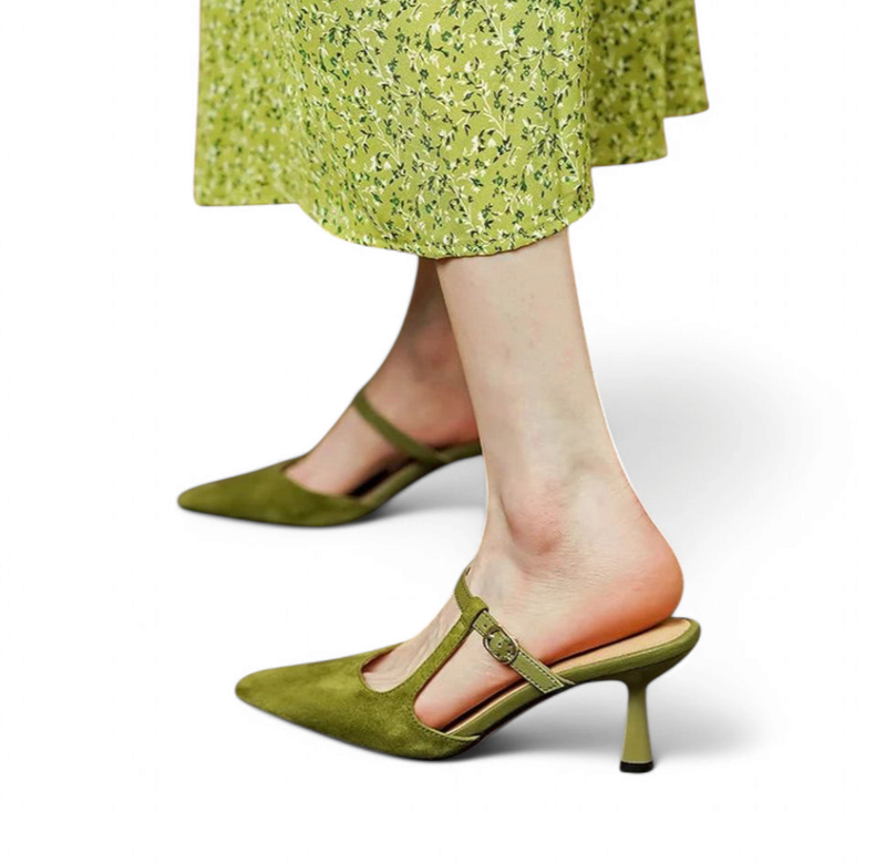 Green Warda mule with kitten heel on model in floral dress, side view.
