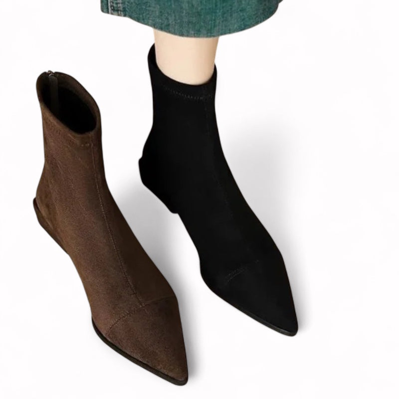 Brown and black ankle boots on a white background