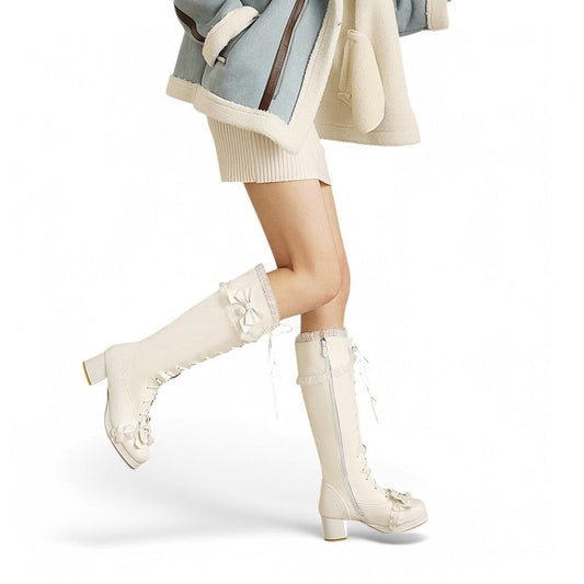 A woman wearing the Merendy Senioreta Victorian boots, shown from a front-side angle. The image highlights the lace-up front, side zipper, rounded toe, and decorative bow near the cuff. The boots are styled with a cozy outfit, combining modern fashion with vintage elegance.