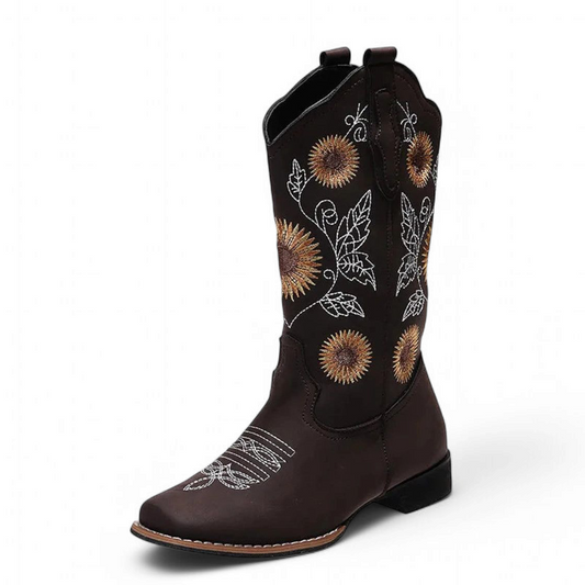 Single brown cowboy boot with sunflower embroidery and contrast welt stitching on white background.
