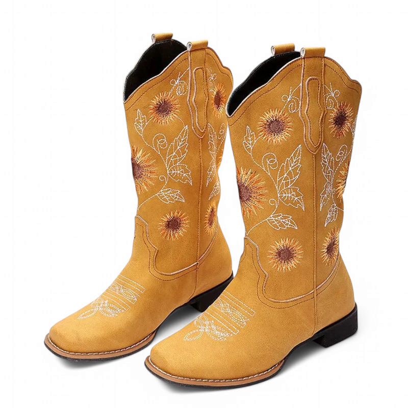 Yellow embroidered cowboy-boot pair with sunflower motif, square toe and low heel, studio shot.