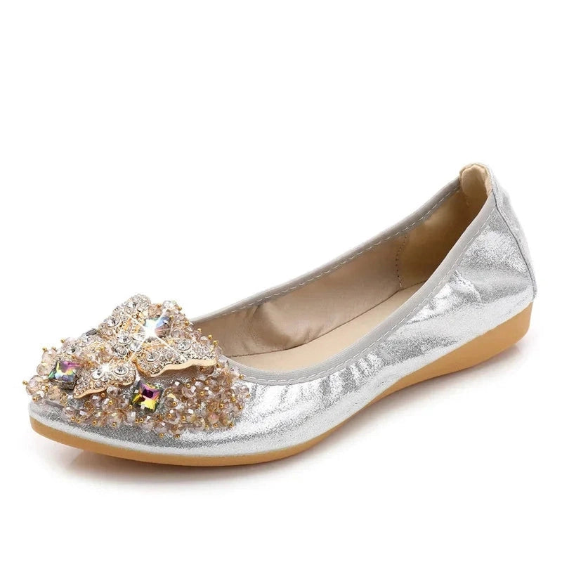 Silver metallic-leather ballet flat with a pointed, crystal-butterfly toe ornament.