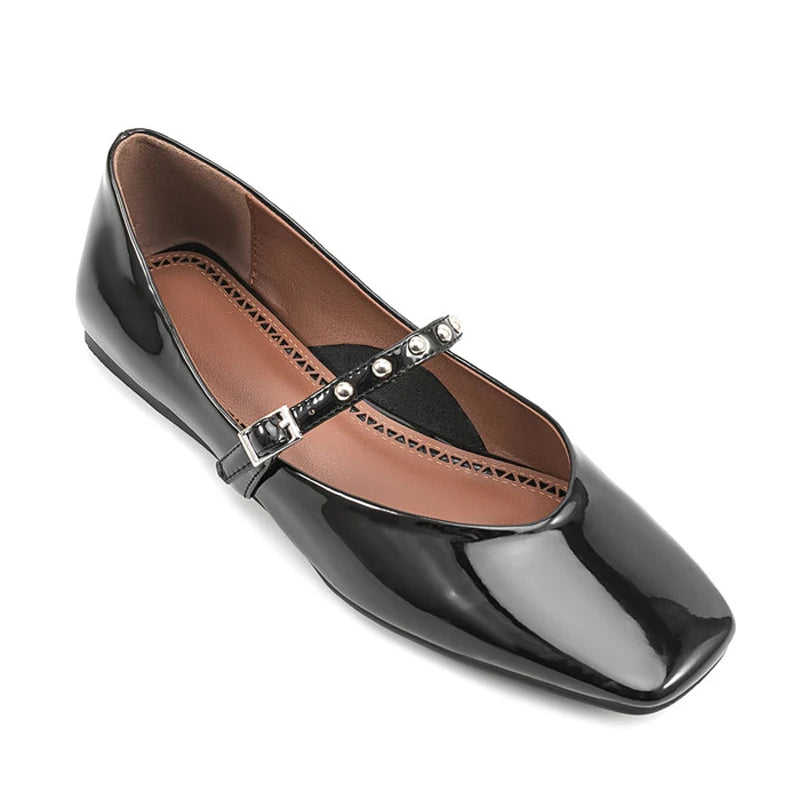 Angled top view showing brown lining, soft square toe, and metal-stud strap.