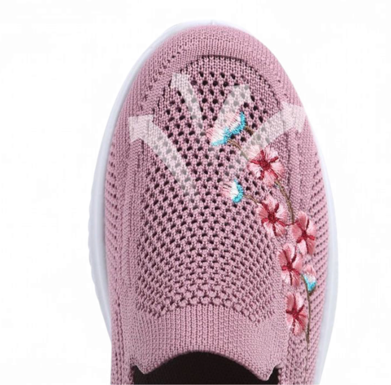 Close‑up of the pink knit toe box with airy mesh pattern and floral embroidery