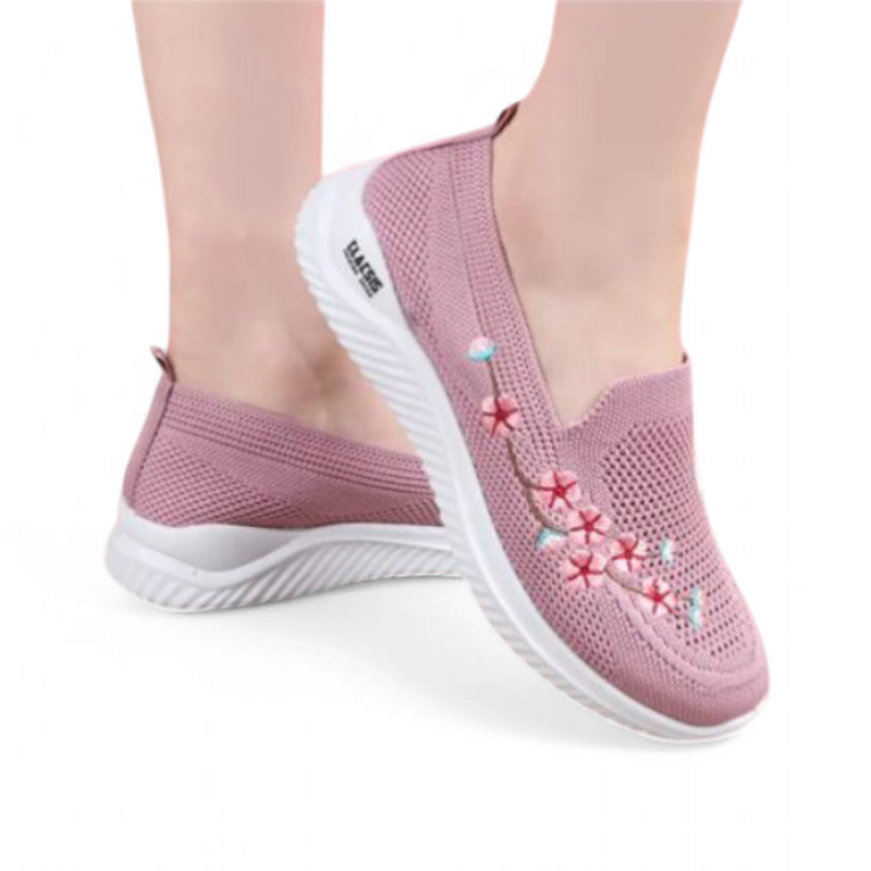 The loafer worn on feet, showing its low white sole and slip‑on design.