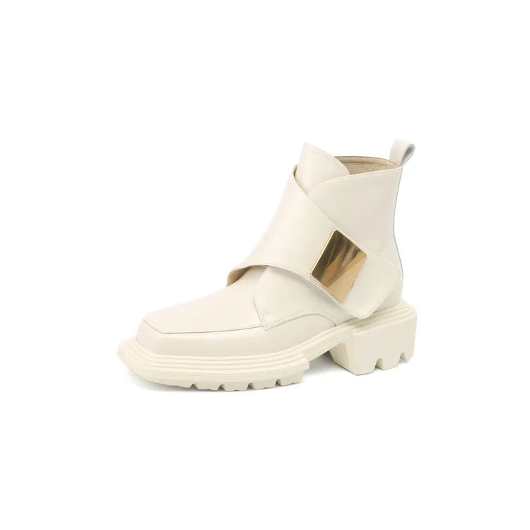 Beige split leather women’s ankle boot with wide metallic front strap on white background