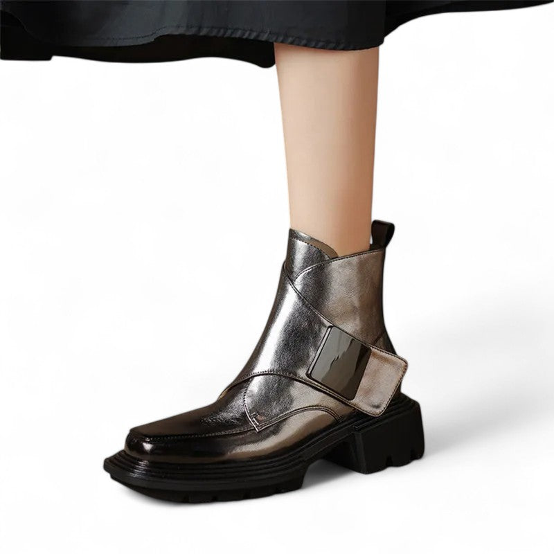 Metallic silver ankle boot worn on foot showing square toe design