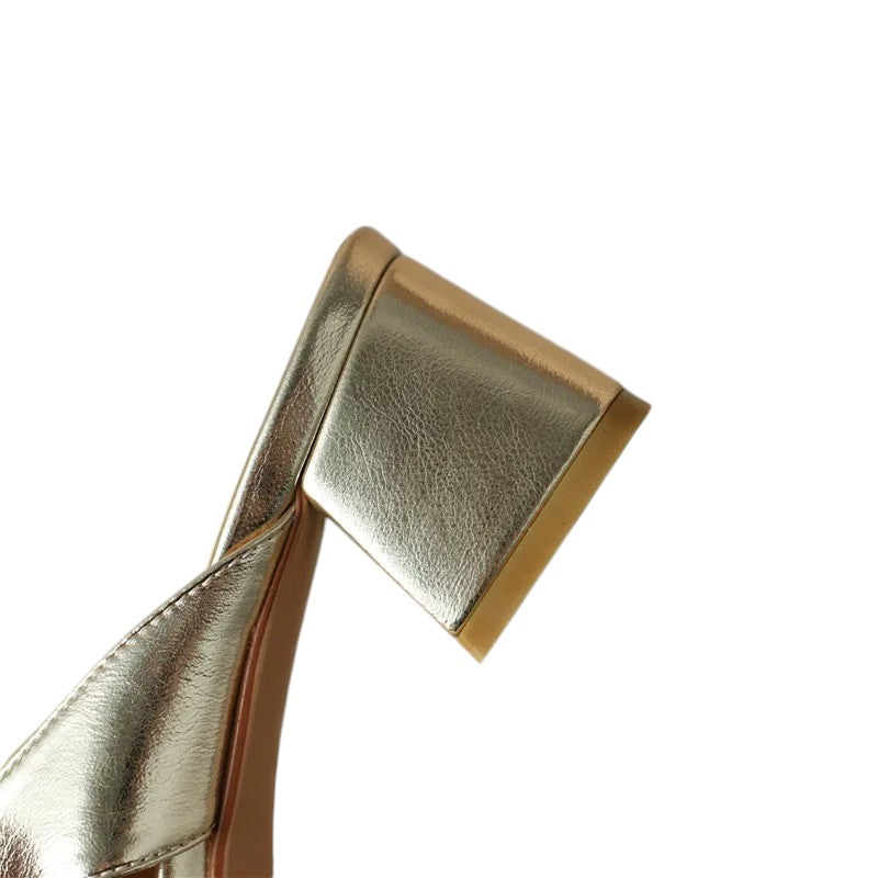 Close-up of the mid chunky heel on Merendy Sortara gold metallic mules

