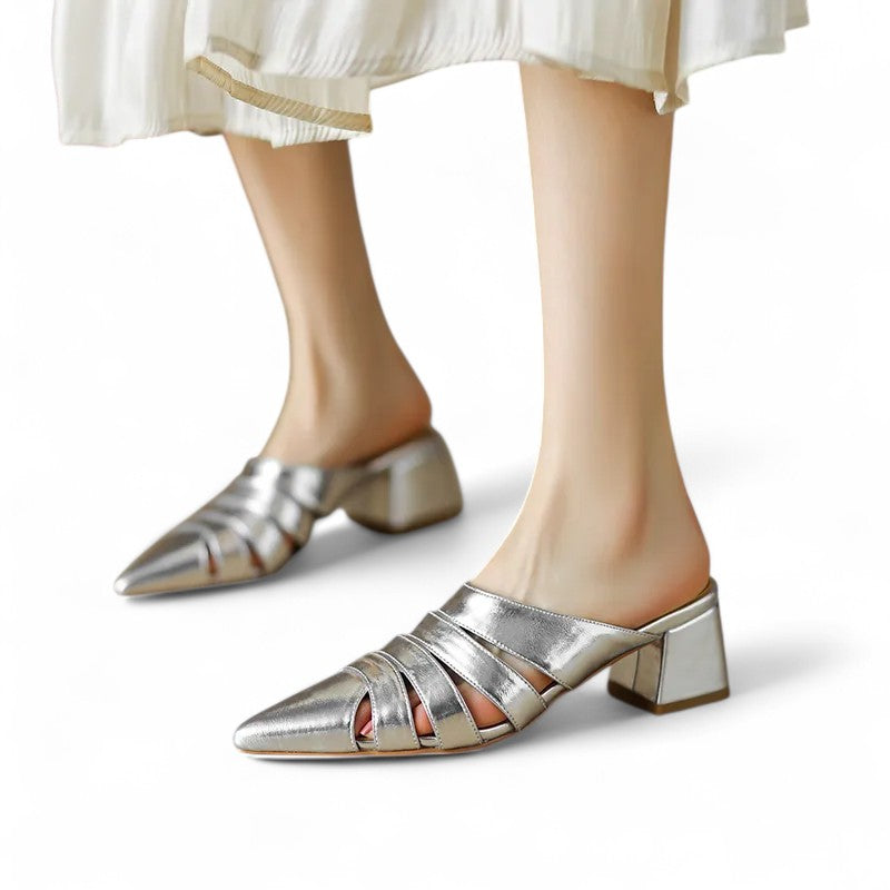 Woman wearing the Merendy Sortara silver metallic mules – front view of both feet