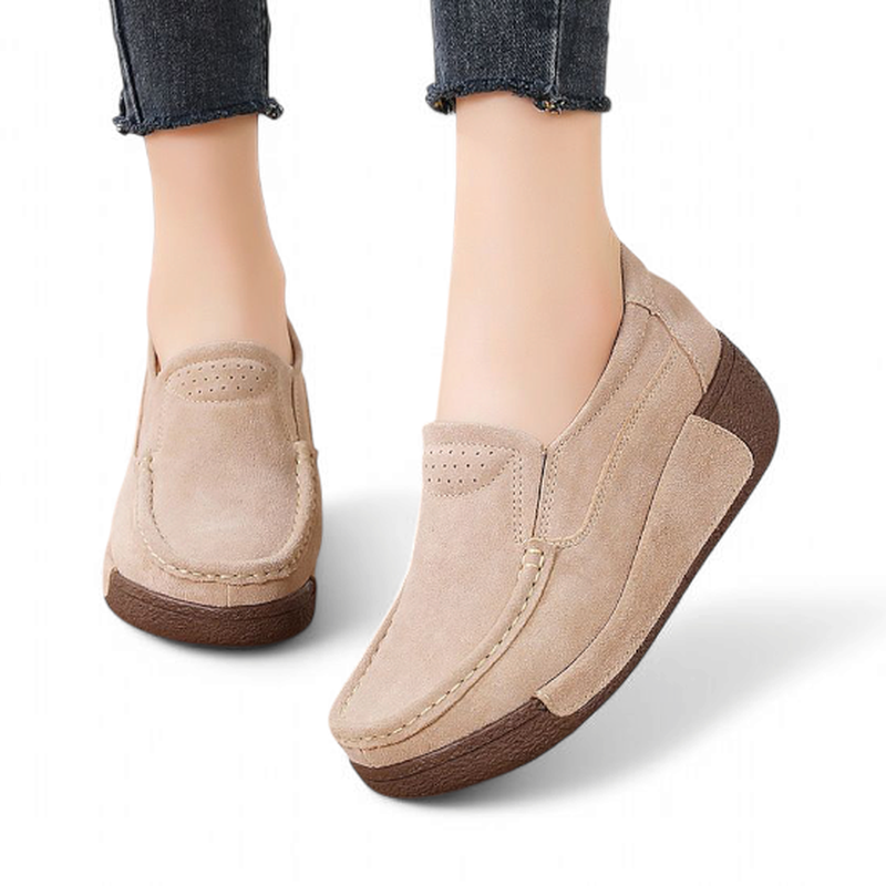 Beige loafers on model’s feet with jeans.